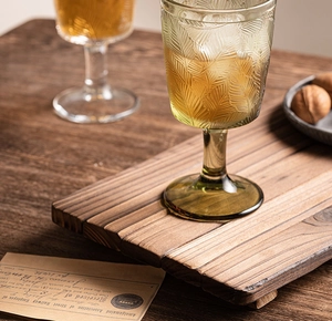 Close-up of a vintage dark wood rectangular tray with striped splice design and natural texture