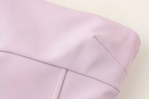 Macro detail of high-quality purple fabric texture and professional stitching on a dress