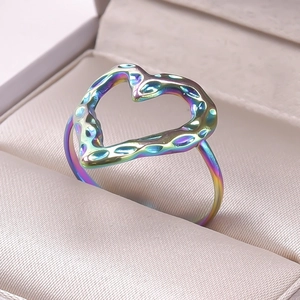 Macro shot of rainbow-plated heart-shaped open ring with unique hammered texture