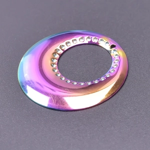 Detailed view of rainbow gradient circular pendant with sparkling rhinestone inlay