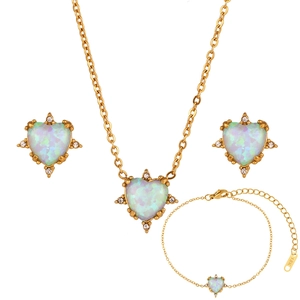 Detailed macro view of 18K gold plated jewelry set with heart opal and white rhinestones