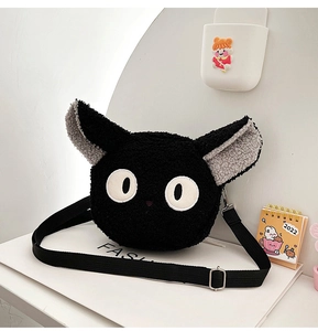 Close-up of black fleece cat-shaped crossbody bag with soft plush texture and large round eyes