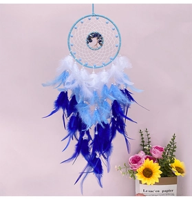 Macro detail of hand-woven Tree of Life dreamcatcher with blue and white feathers