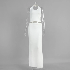 Detail of white knit set featuring halter neck top and ribbed texture maxi skirt