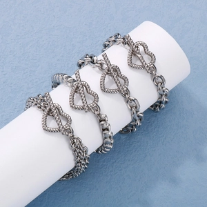 Three silver layered bracelets with heart T-bar toggle closure on white display stand