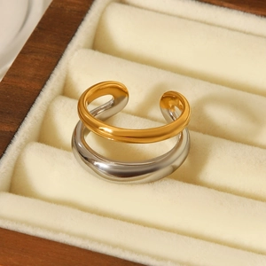 Close-up of two-tone gold and silver steel ring on velvet jewelry box liner