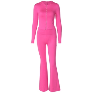 Detail of rose red tracksuit featuring a zip-up hoodie and high-waisted flared pants