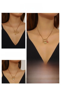 Detailed view of layered gold necklaces featuring sea horse, celestial, and evil eye charms