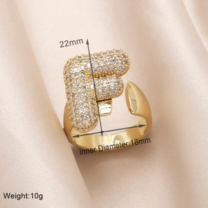 Detail of gold letter F ring with cubic zirconia paving and dimensions 22mm by 18mm