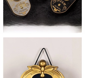 Macro shot of mechanical push-to-ring doorbell in vintage gold and matte black finish
