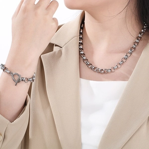 Chunky silver titanium steel necklace and bracelet set with OT toggle clasp on model