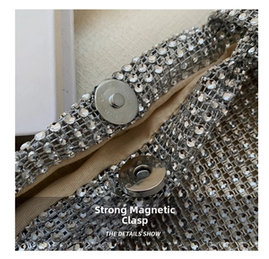 Close-up of dual silver magnetic buckles on a luxury rhinestone handbag detail