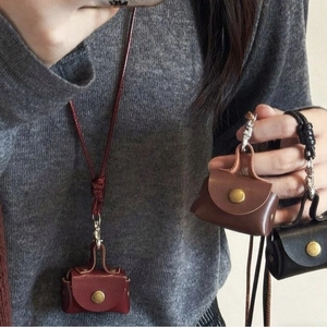 Mini leather puppy-style neck pouches in burgundy, brown and black for headphones