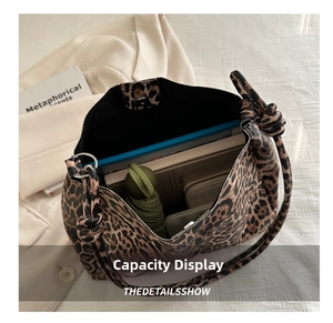 Interior view showing the large capacity of the leopard print tote with daily essentials