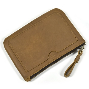 Detail of vintage brown genuine leather coin purse with zipper and wrist strap