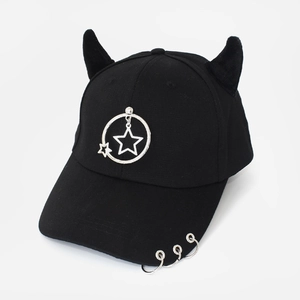 Detail of black baseball cap with furry devil horns and silver metal ring star charm