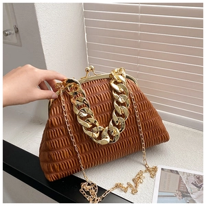 Detailed view of brown pleated shell bag with chunky gold chain strap and metal frame