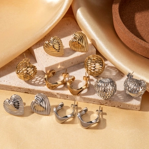 Minimalist stainless steel earrings set featuring heart and hollow geometric designs