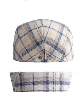 Close-up of vintage wool plaid flat cap with adjustable dark metal buckle detail