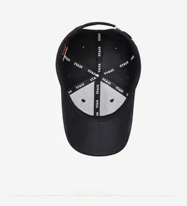Internal view of the black cotton baseball cap showing printed seam tape and metal buckle