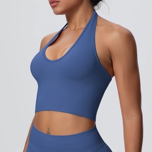 Macro detail of navy blue ribbed sports bra fabric and halter neck construction