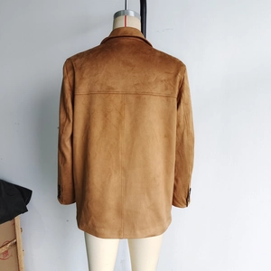 Detail shot of the back view of a brown suede blazer for women featuring smooth texture