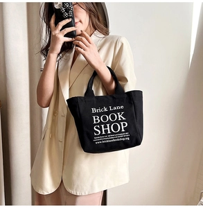 Detailed view of black canvas tote bag with white Brick Lane Bookshop lettering