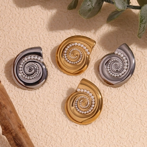 Chic conch earrings with white faux pearls in gold and silver finish on a textured base