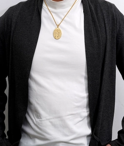 Close-up of a model wearing an 18K gold stainless steel religious oval pendant necklace