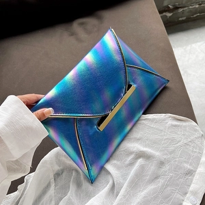 Detail of blue laser metallic envelope clutch bag with gold bar and minimalist design