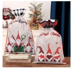 Detail of Christmas burlap drawstring gift bags with gnome prints and plaid borders