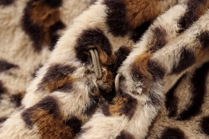 Detailed macro view of leopard faux fur texture with hidden metal hook closure