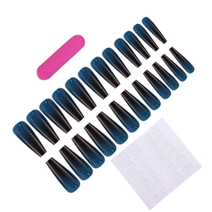 Flat lay of gradient black-blue coffin fake nails with file and adhesive glue stickers