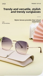 Detail of gradient pink-purple nylon sunglasses with gold metal frame on a stylish backdrop