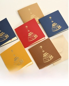 Detailed view of 3D birthday cards with gold foil patterns and matching envelopes