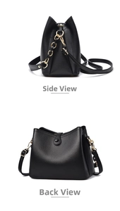 Detail view of black lychee grain leather bag with gold hardware and metal chain strap