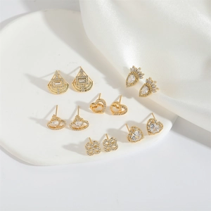 Set of six gold-plated stud earrings featuring heart and flower designs with cubic zirconia