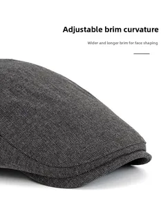 Detail of the wide adjustable brim and grey knit texture on this classic flat cap