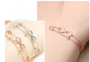 Detail of infinity symbol bracelet with micro-pave crystals and double layer chain design