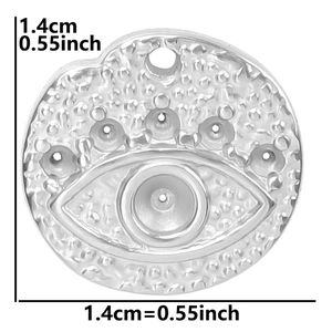 Macro detail of silver Evil Eye pendant with embossed texture and 1.4cm dimension label