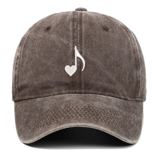 Detail of dark brown washed cotton baseball cap with white heart music note embroidery