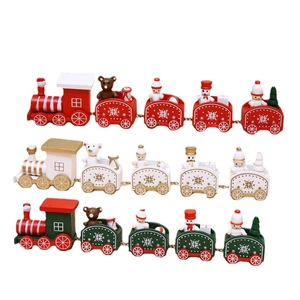 Three wooden Christmas train ornaments in red, white and green for festive table decoration