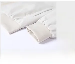 Detail of elastic ribbed cuffs on a white casual jacket for windproof fit and comfort