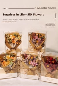 Detailed view of mini artificial silk flower bouquets in transparent PVC gift boxes