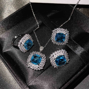 Luxury jewelry set with square blue gemstones and crystals in a black gift box