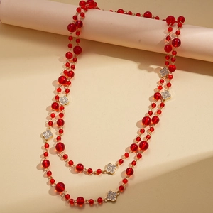 Elegant red beaded long necklace with gold chains and sparkling rhinestone clover accents