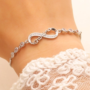 Macro shot of silver infinity Grandma bracelet with sparkling white zircon stones