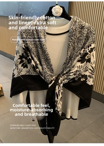 Detail of black and white cotton linen scarf featuring large floral patterns and dots