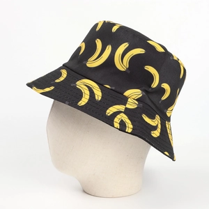 Detail of black canvas bucket hat with all-over yellow banana print on a mannequin head
