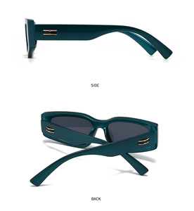 Detail view of dark green rectangular sunglasses with golden side buckle and grey lenses